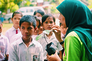 Teacher talking to students about rainforest conservation