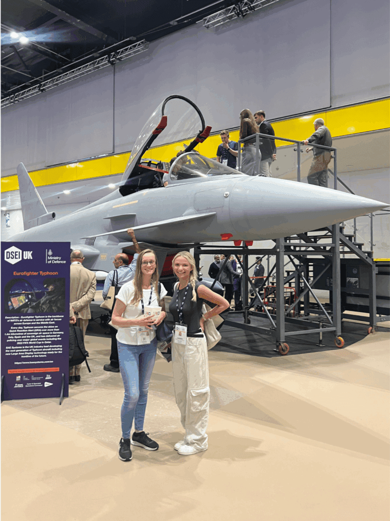Two people in front of Eurofighter Typhoon at DSEI 2025